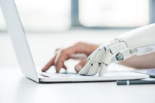 selective-focus-of-human-and-robot-hands-typing-on-2024-11-19-08-41-43-utc